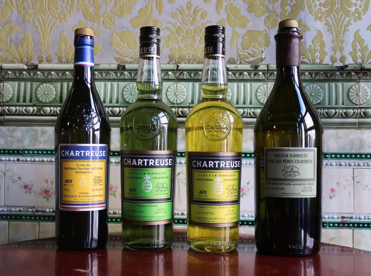 The Sassafras Chartreuse collection includes Chartreuse VEP, MOF, Green, and Yellow bottles against the bar’s signature vintage tile in Old City Philadelphia.