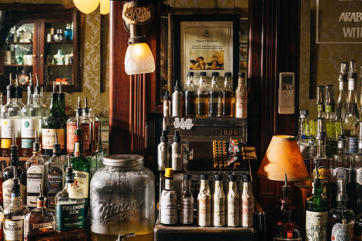 The Sassafras back bar in Old City Philadelphia features Irish whiskeys, bitters, and an antique cash register that defines the Grand Dame aesthetic.