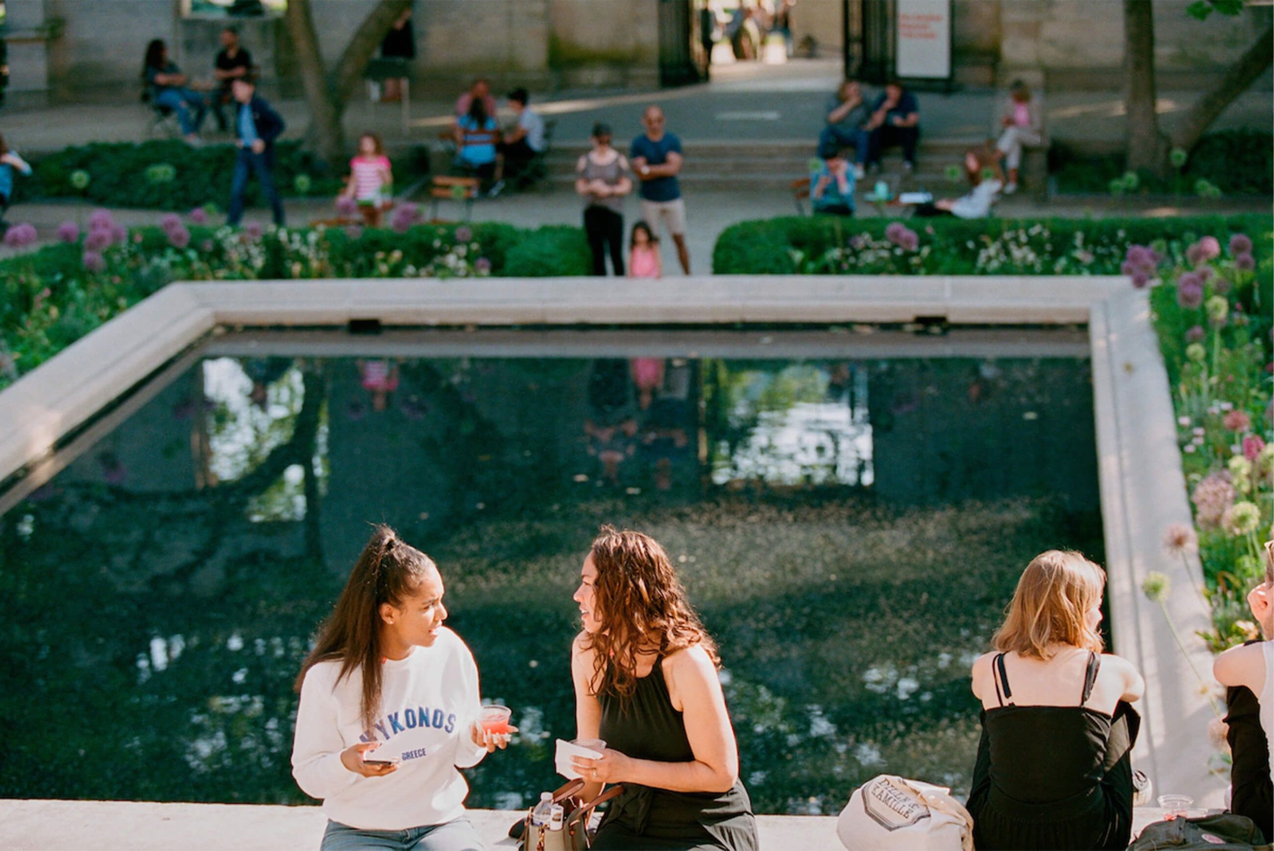 The Rodin Museum Garden Bar Returns May 29 With a New Food Truck and a Crossing Choir Performance 4 Friends share drinks at the edge of the Rodin Museum’s reflecting pool during a summer Garden Bar evening on the Benjamin Franklin Parkway.
