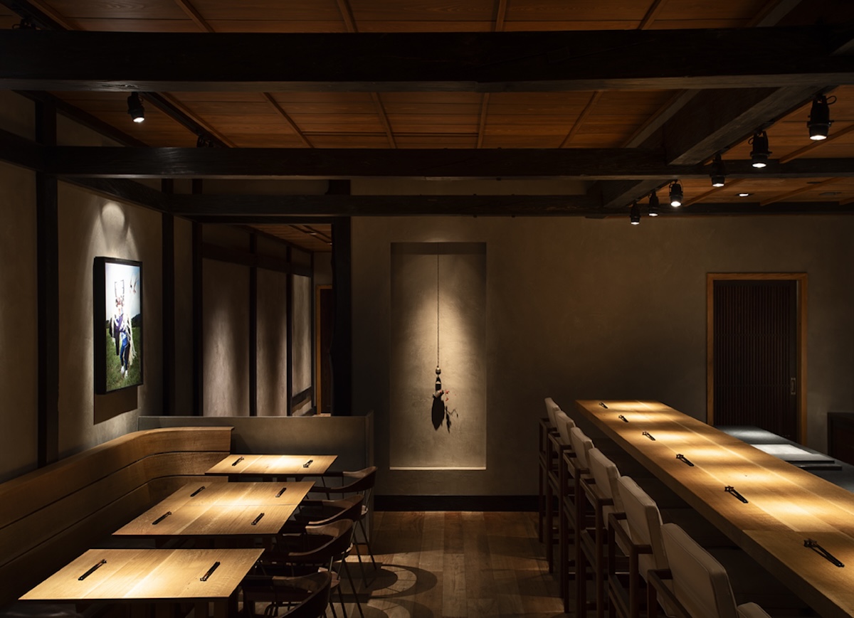 The dining room at Hiroki Omakase Philadelphia in Fishtown showing exposed wooden beam ceiling, sushi counter seating, and Japanese-inspired interior design.